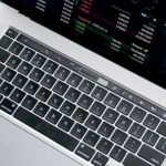 Stock Market - Person Using Macbook Pro on White Table