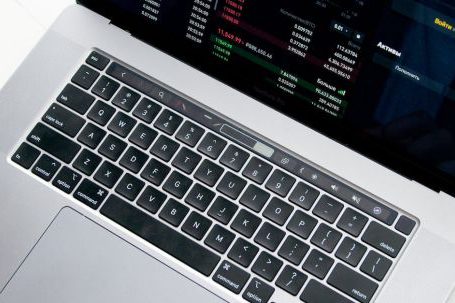 Stock Market - Person Using Macbook Pro on White Table