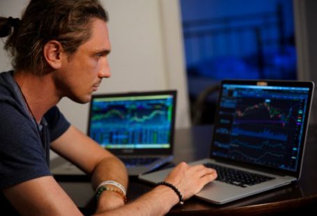 Stock Trading - man sitting in front of the MacBook Pro
